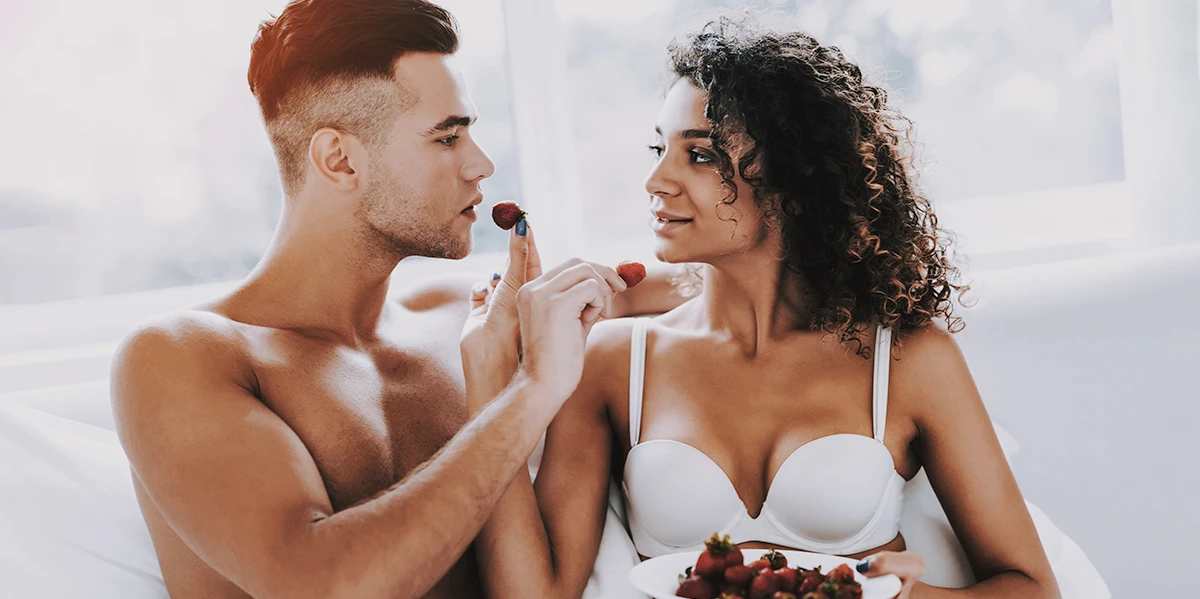 Sexy couple tasting food together