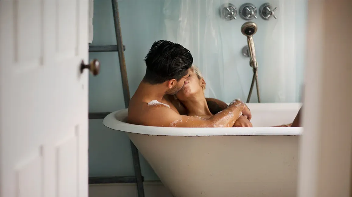 Couple kissing in a bath