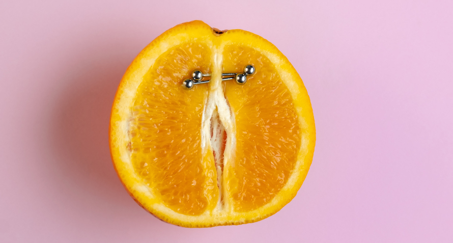 An orange with a piercing
