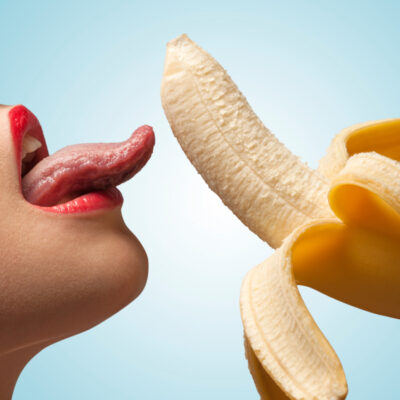 Woman is licking a banana
