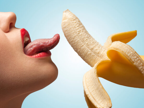 Woman is licking a banana