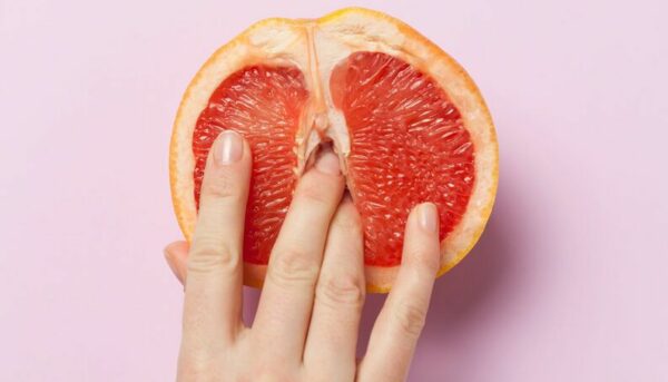 An orange with fingers in it