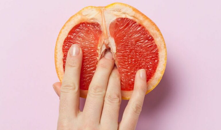 An orange with fingers in it