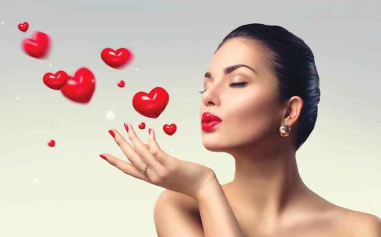 Sexy woman is blowing hearts in the air