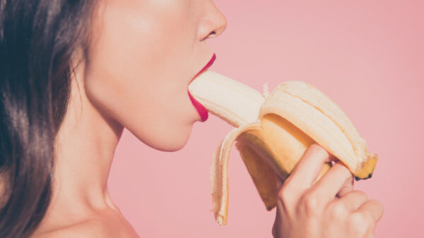 Woman with banana in her mouth