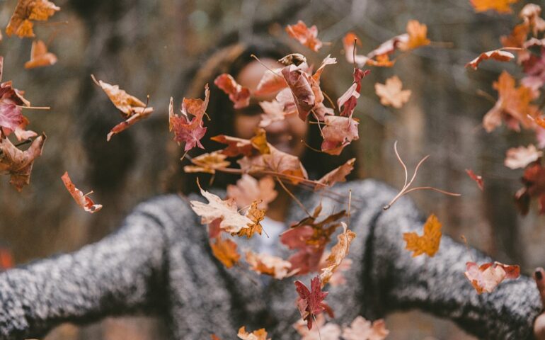 Woman with leaves all over her