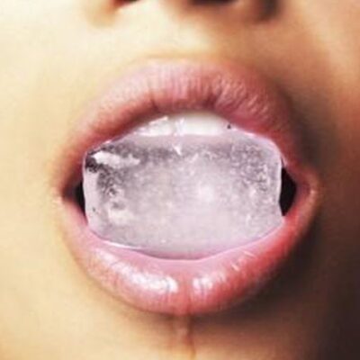 Woman with icecube in her mouth
