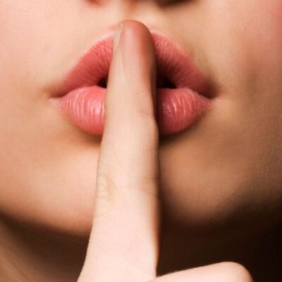 Woman holding her finger on her lips