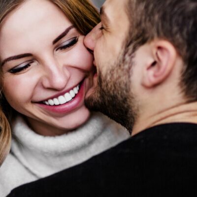 Man and woman cuddling and laughing