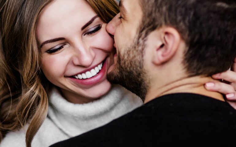 Man and woman cuddling and laughing