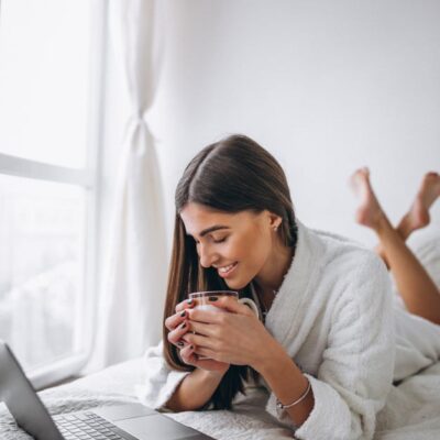 Woman on bed with laptop