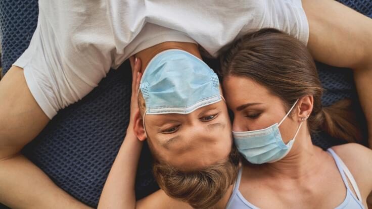 Man and woman with facemasks on