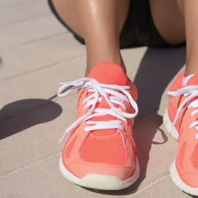 Woman with running shoes and juice