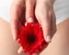 Woman with red flower between her legs